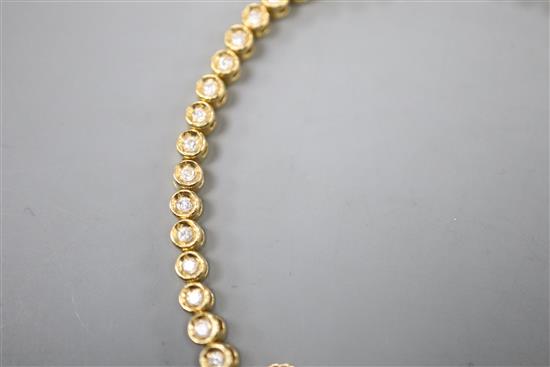 An 18ct gold and diamond set line bracelet, with safety chain, approx. 18cm, gross 12.8 grams.